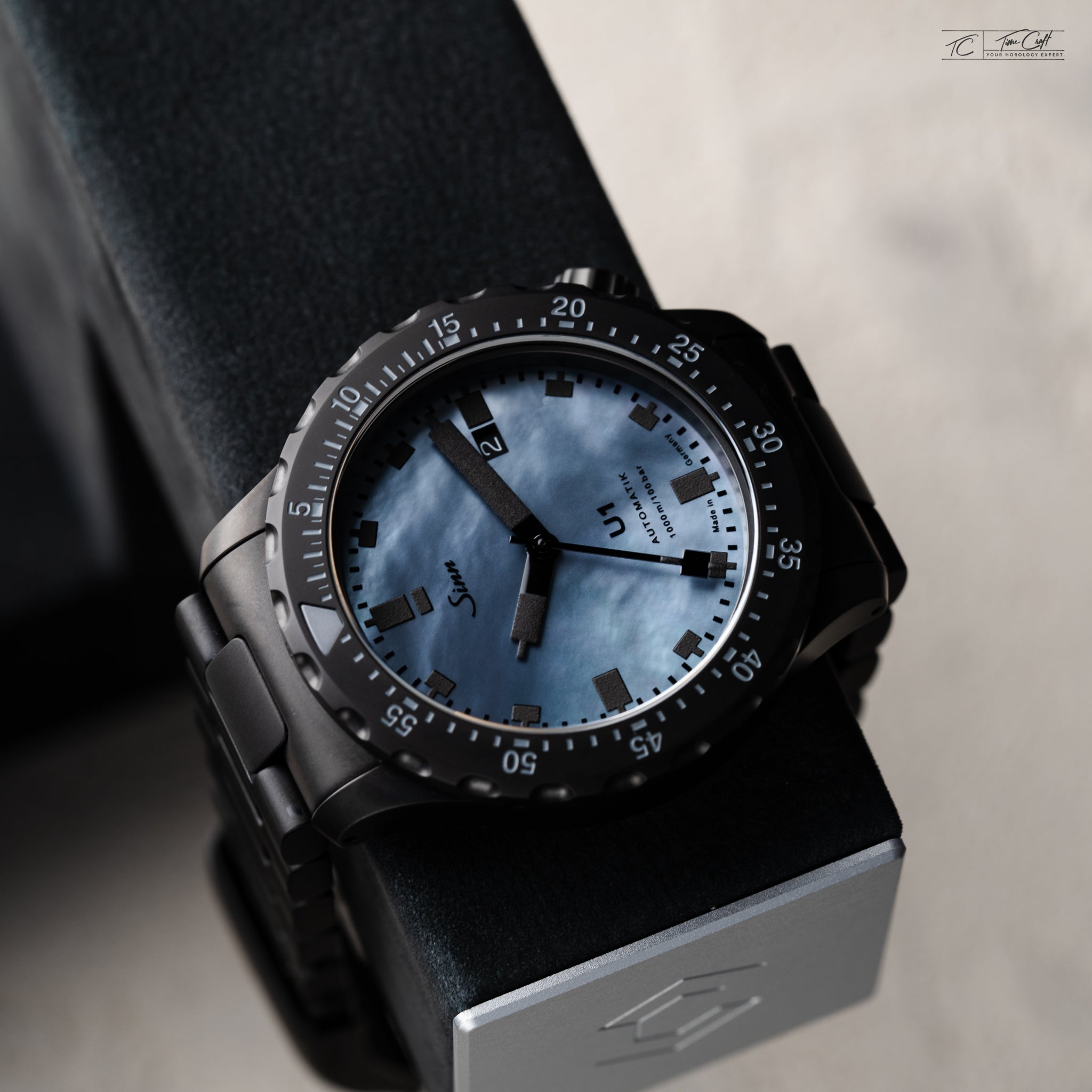 Sinn U1 Mother of Pearl on Charles Simon watch stand